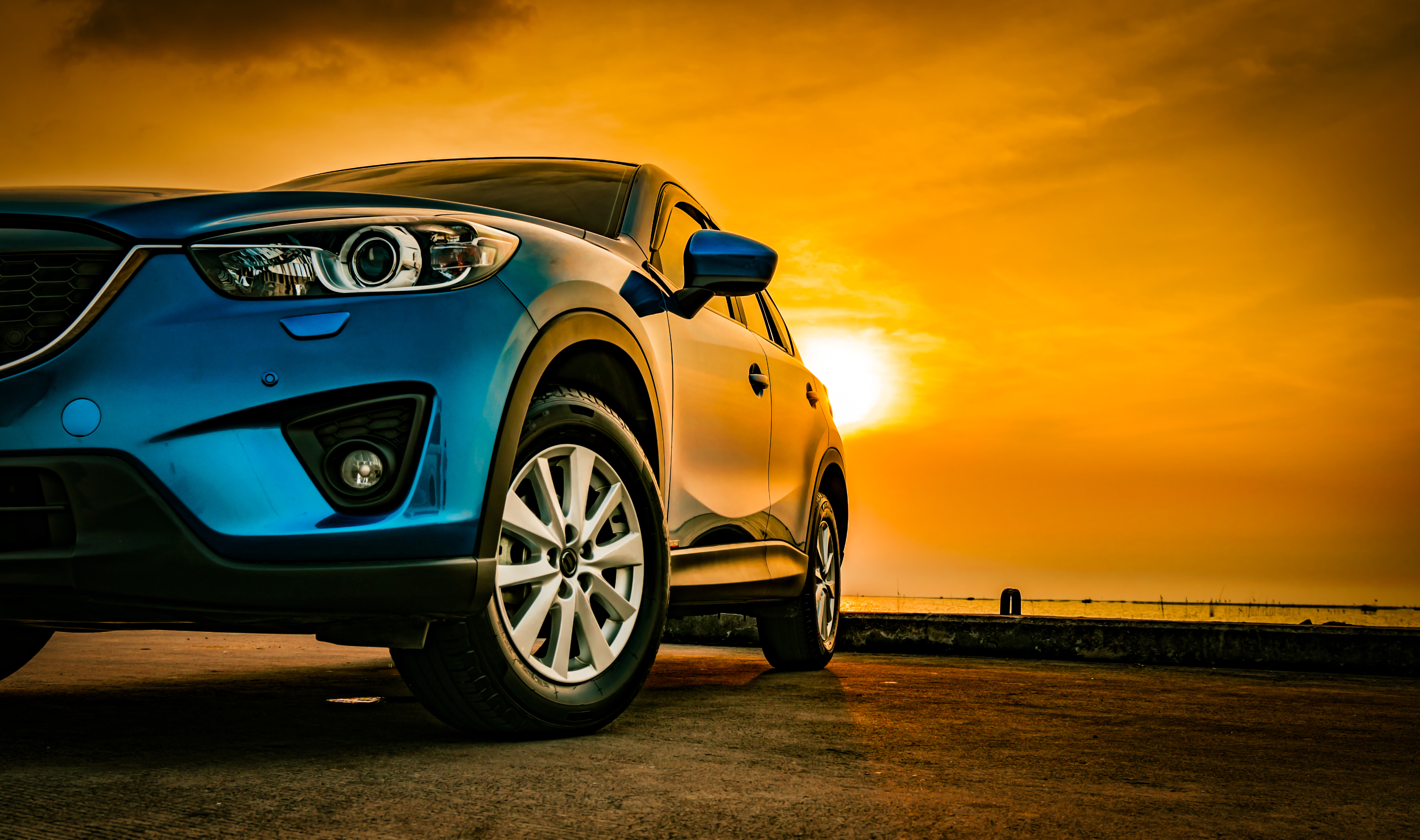 Blue car at sunset